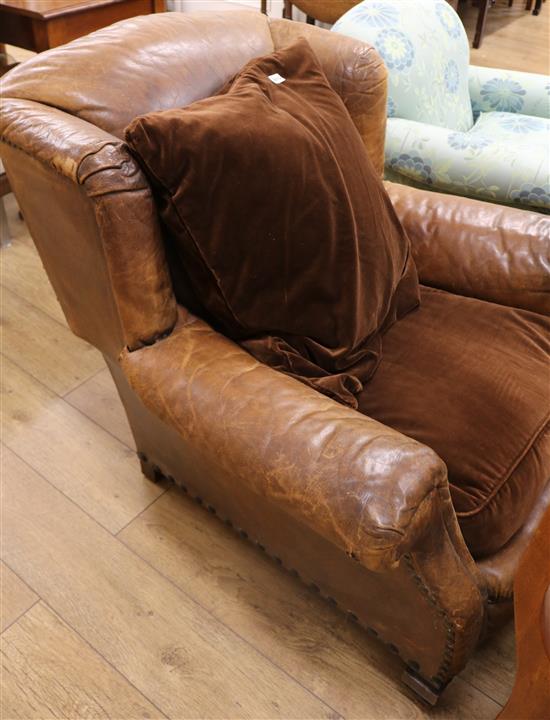 A 1930s French leather wing armchair